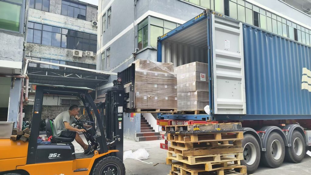 Palletized goods being loaded into a shipping container