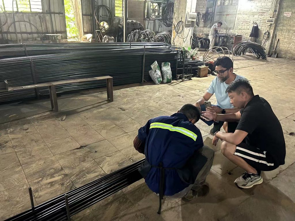 GAZLL reviewing an aluminum product with factory staff